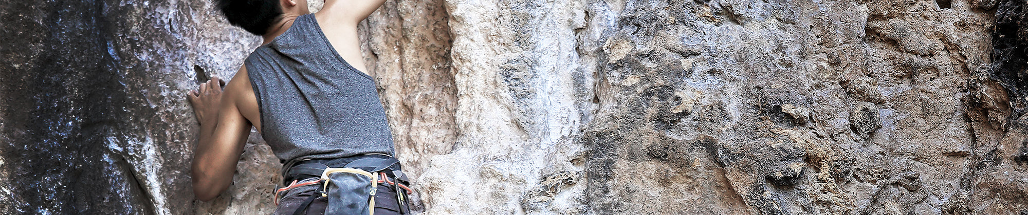 Active lifestyle banner featuring a person rock climbing on a rugged cliff face; no visible text, highlighting strength, endurance, and physical performance.
