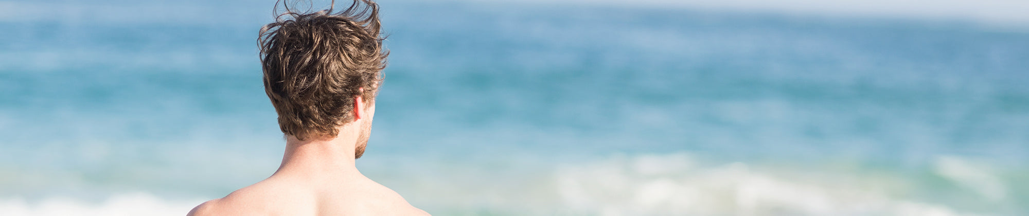Lifestyle banner featuring a person looking out at the ocean from the shore; no visible text, highlighting relaxation, mindfulness, and overall wellness.