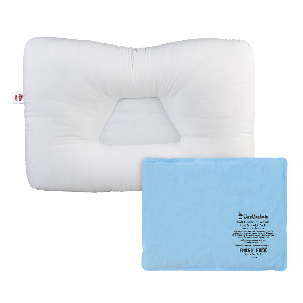 White contoured orthopedic pillow with a recessed center for neck support, shown with a Large blue Soft Comfort CorPak 10" x 13" hot/cold pack placed on top. The pack displays text including “Soft Comfort CorPak,” “Hot or Cold Pack,” “Microwaveable and reusable,” “Frost Free,” and “Made in USA.” A small Core Products red apple logo tag is visible on the pillow.