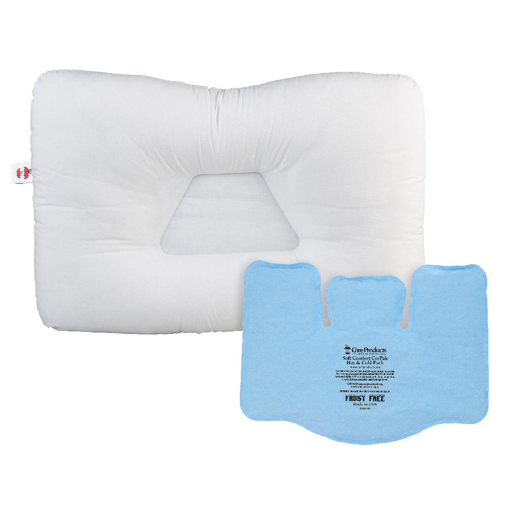White contoured orthopedic pillow with a recessed center for neck support, shown with a blue Soft Comfort CorPak 11" x 15"Tri-Sectional hot/cold pack placed on top. The pack displays text including “Soft Comfort CorPak,” “Hot or Cold Pack,” “Microwaveable and reusable,” “Frost Free,” and “Made in USA.” A small Core Products red apple logo tag is visible on the pillow.