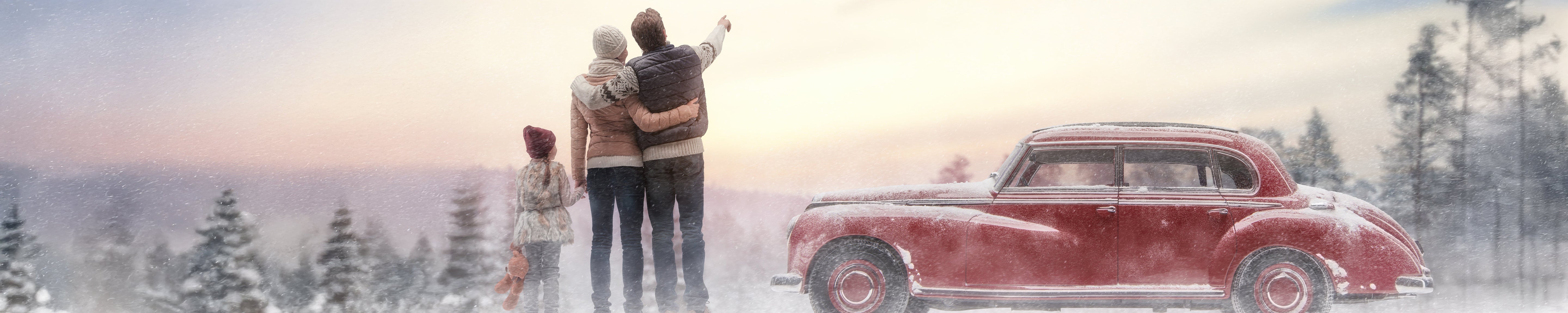Person and two companions standing in a snowy landscape beside a vintage red car, with one pointing toward the distance, representing winter travel, family bonding, and scenic outdoor adventure.